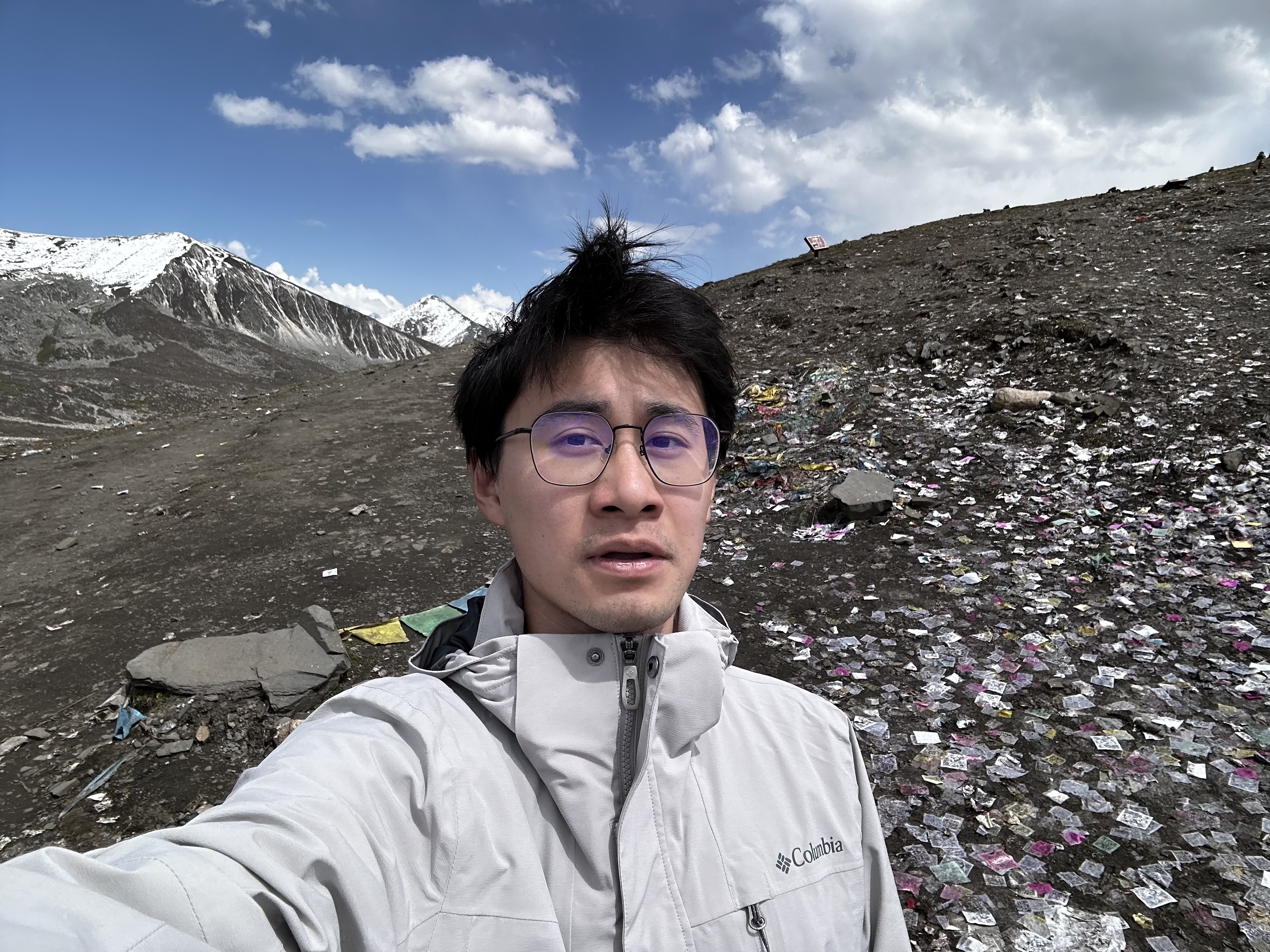 Xinlong Du taking a selfie in a mountain landscape